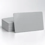 Blank grey PVC cards with a single card in front of a neat stack