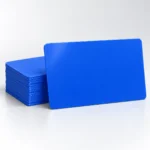 Blank royal blue PVC cards with a single card in front of a neat stack