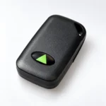 Black Paxton Net2 hands-free fob with a green triangle